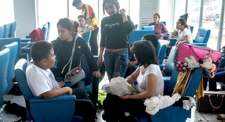 Survivors of the Zahro Express fire -- the boat's captain has been held by Indonesian police for suspected negligence