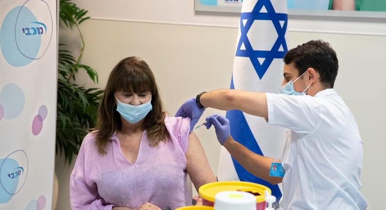 An Israeli woman receives a third Pfizer-BioNTech COVID-19 vaccine in Ramat Ha Sharon on July 30, 2021.