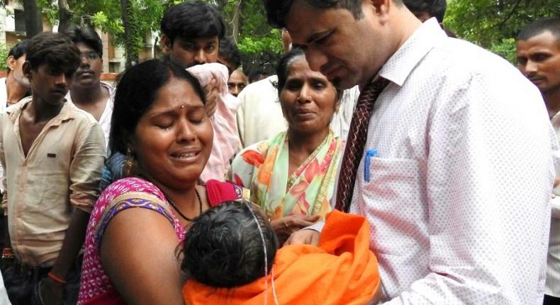 This file photo taken on August 12, 2017 shows relatives mourning the death of a child at the Baba Raghav Das Hospital in Gorakhpur, in the northern Indian state of Uttar Pradesh