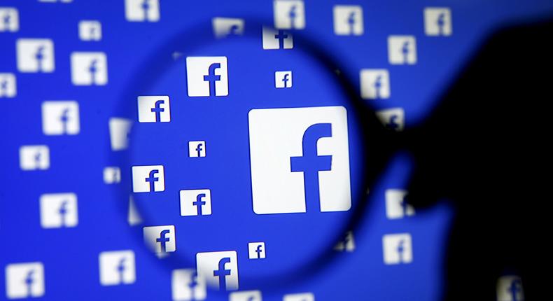 FILE PHOTO: A man poses with a magnifier in front of a Facebook logo on display in this illustration taken in Sarajevo, Bosnia and Herzegovina, December 16, 2015.   REUTERS/Dado Ruvic/Illustration