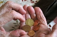 Old woman holds coins