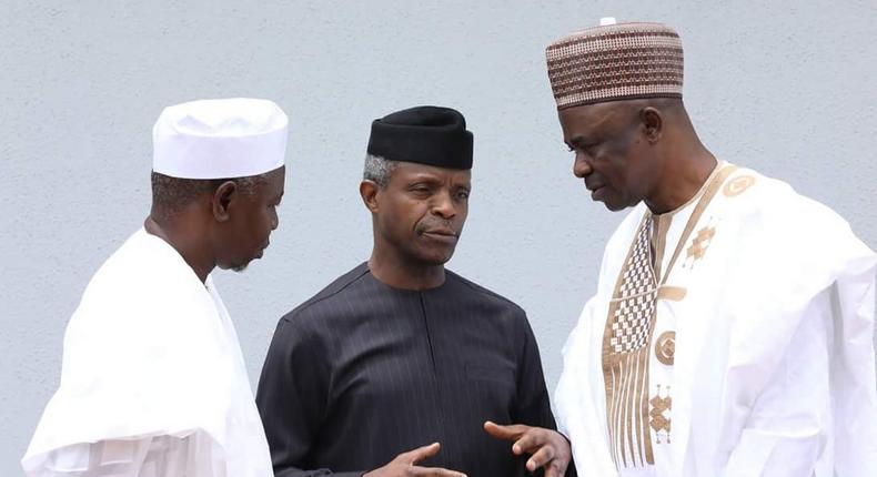 Acting President, Yemi Osinbajo (middle) with Stephen Ocheni (right) and Suleiman Hassan (left) at the swearing in ceremony