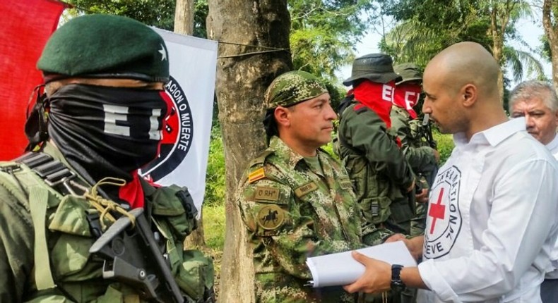 Colombian Soldier Fredy Moreno (C) who was kidnaped by National Liberation Army (ELN), shakes hands with a Red Cross member next to ELN guerrillas, before his release in Arauca, Colombia on February 6, 2017