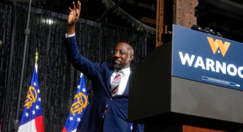 Georgia Sen. Raphael Warnock waves to the crowd after speaking at a campaign rally featuring former President Barack Obama at Pullman Yards in Atlanta, Ga., on December 1, 2022.AP Photo/Brynn Anderson