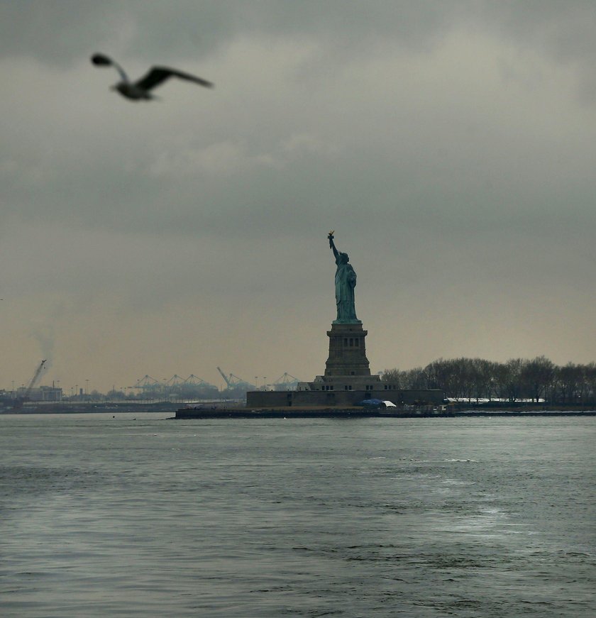 A sign announcing the closure of the Statue of Liberty, due to the U.S. government shutdown, sits ne