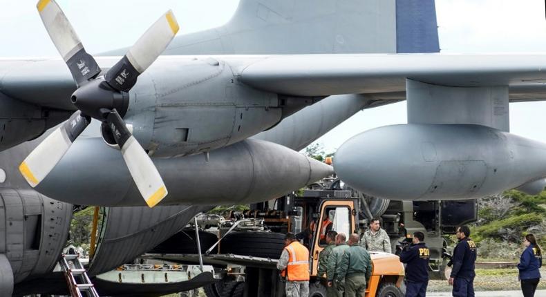 Chilean military personnel on December 13, 2019 offload the landing gear from the Hercules C-130 air force plane that crashed on its way to Antarctica, killing all 38 people on board