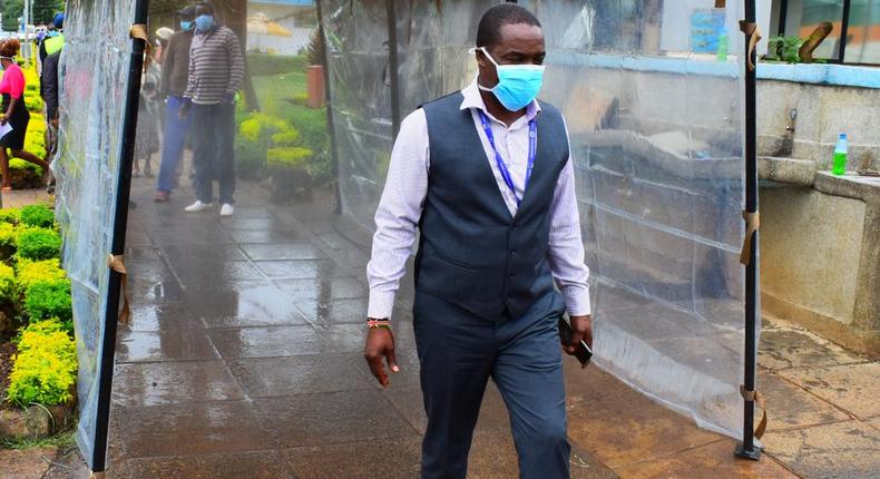 KNH CEO Dr Evanson Kamui goes through a sanitization booth donated by Sonko Rescue Team