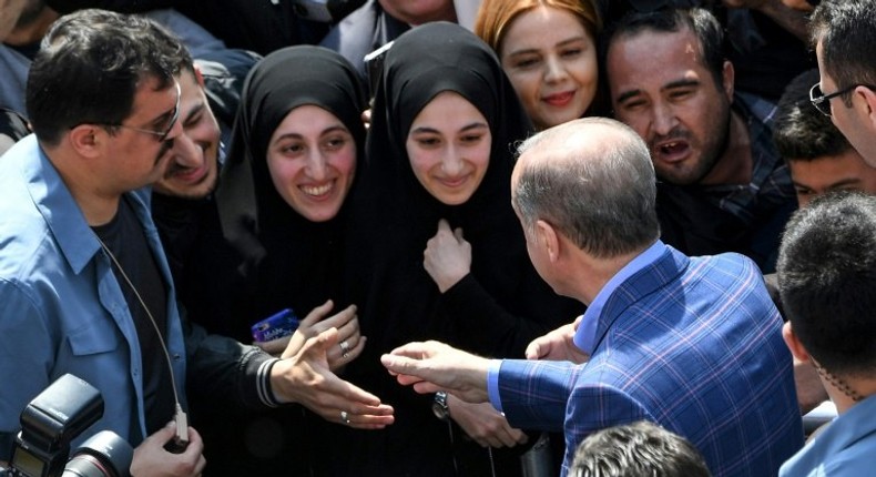 President Recep Tayyip Erdogan greets supporters as Turks vote on whether to grant him extended powers