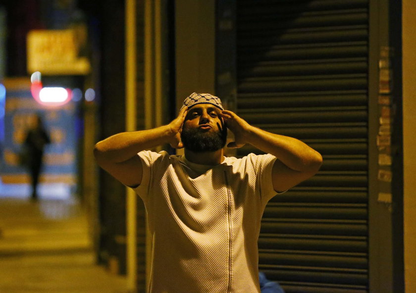 A man prays after a vehicle collided with pedestrians near a mosque in the Finsbury Park neighborhoo