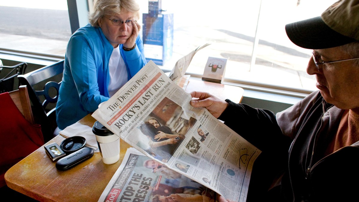 Vicki, left, and Dan Rubin look at the final edition of the