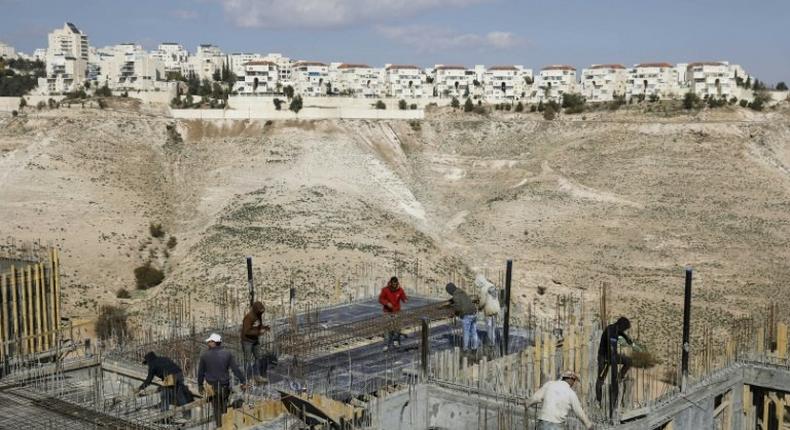 Palestinian labourers work on a construction site in the Israeli settlement of Maale Adumim, east of Jerusalem, on January 22, 2017