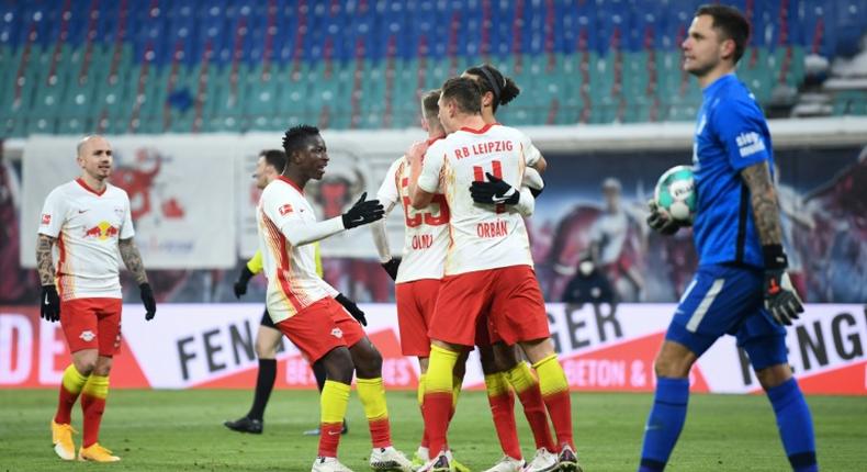 Leipzig celebrate after Dani Olmo converts a penalty against Augsburg