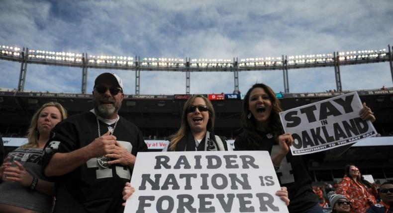 Oakland Raiders fans hold signs before the game against the Denver Broncos at Sports Authority Field at Mile High on January 1, 2017 in Denver, Colorado