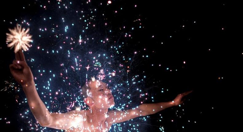 A Fangshan villager performs the 'eating flowers' ritual - bathing in a shower of scorching sparks - to wash away the taint of evil spirits