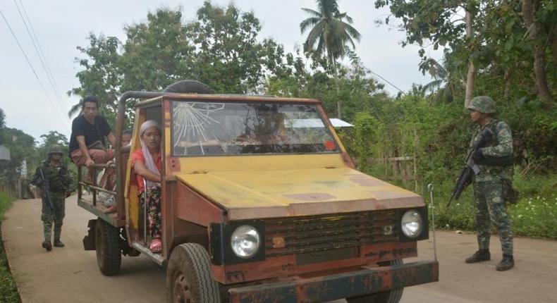 Philippine marines check a passenger jeepney at a check point in Indanan town in Sulu province on the southern island of Mindanao on February 27, 2017