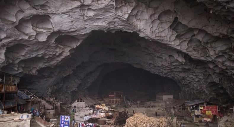 Zhongdong village, where a group of 18 families live inside an enormous natural cave with all the modern conveniences, like electricity