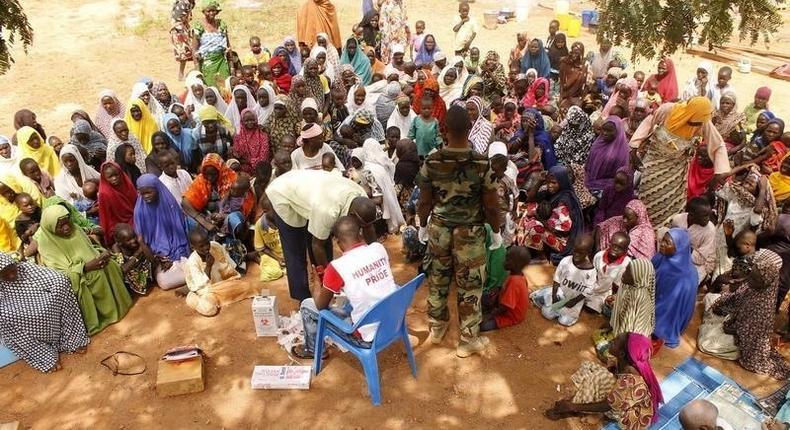People who were rescued after being held captive by Boko Haram, sit as they wait for medical treatment at a camp near Mubi, northeast Nigeria October 29, 2015. REUTERS/Stringer