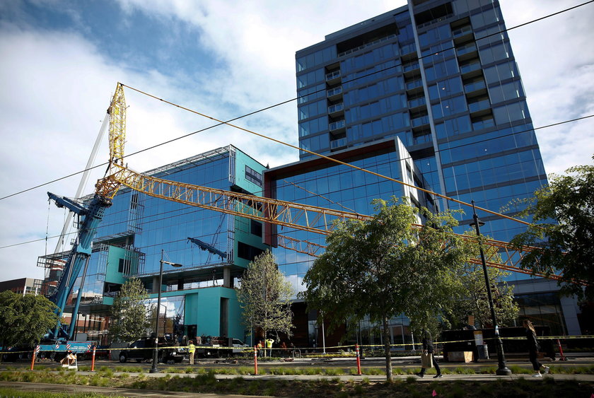 Part of a construction crane that fell in a deadly accident is removed from the scene on Mercer Stre