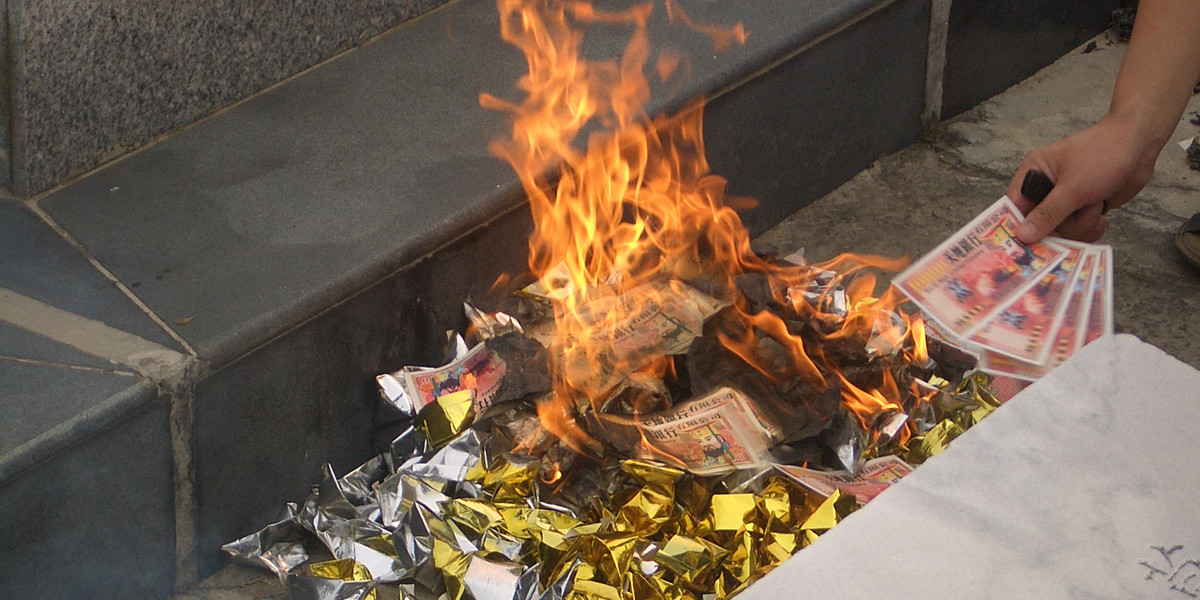 Joss paper "hell money" and joss yuanbao being burnt at ancestors' graves around the time of the Ghost Festival.