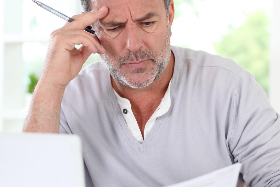 Senior man being puzzled with tax documents