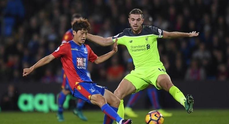 Crystal Palace's Lee Chung-yong in action with Liverpool's Jordan Henderson 