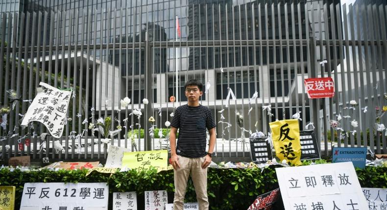Hong Kong democracy activist Joshua Wong poses during an interview with AFP outside the government headquarters
