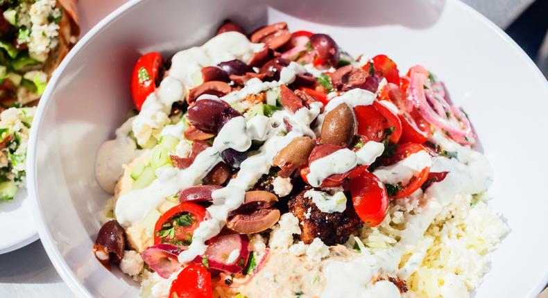 The grain bowl — $9.87, with the choice of saffron basmati rice, brown rice, or black lentils — is packed with deliciousness. I opted for hummus, eggplant and red pepper spread, spicy lamb meatballs (an extra $1.75), tomatoes, onions, olives, and feta, all drizzled with a cool yogurt dill sauce.