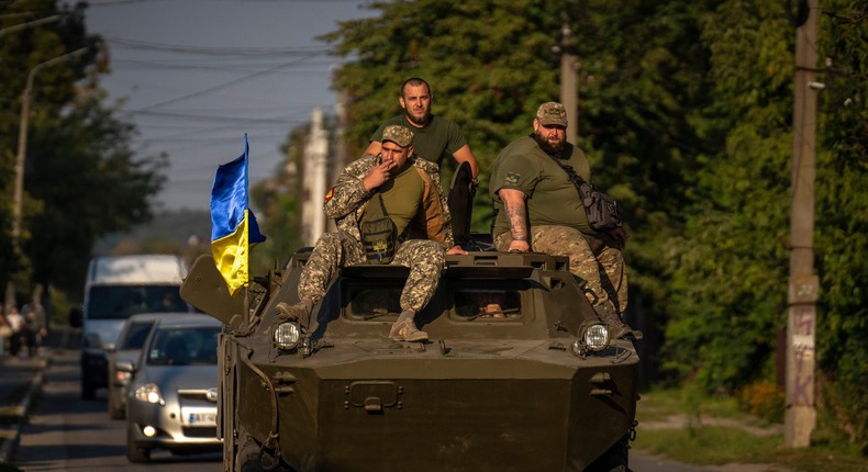 Ukrainian army soldiers sit on an armor military vehicle on September 8, 2022.