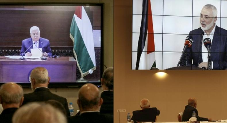 Palestinian factions gathered at their embassy in Beirut attend by video conference talks with president Mahmud Abbas (screen), while their counterparts in the West Bank watch speech of Hamas chief Ismail Haniyeh in Beirut