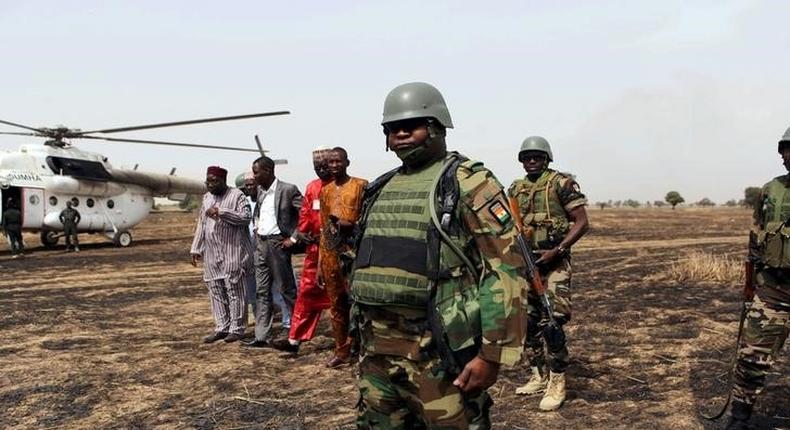 Colonel Barmou Salaou (C), commander of Niger's armed forces in the Diffa region, looks on after landing in Damasak 