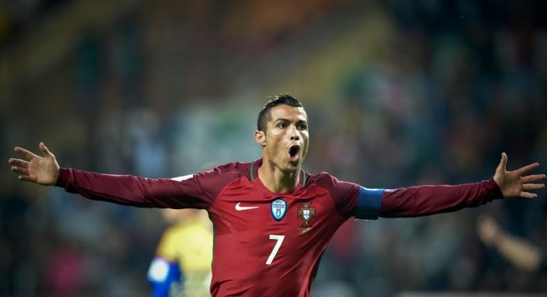 Portugal's forward Cristiano Ronaldo celebrates after scoring a goal during the WC 2018 football qualification match between Portugal and Andorra at the Municipal de Arouca stadium in Aveiro on October 7, 2016