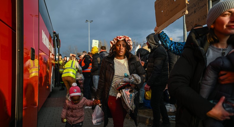 Nigerian citizens, Victoria and her daughter, Elvira arrive by bus to the Polish-Ukrainian border crossing February 26, 2022 in Przemysl, Poland