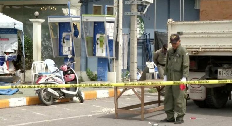 Police Explosive Ordnance Disposal (EOD) official inspects the site of a bomb blast in Hua Hin, south of Bangkok, Thailand, in this still image taken from video August 12, 2016. 