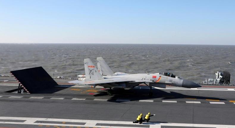 China's Liaoning aircraft carrier battle group has conducted its first live-fire exercises in drils involving dozens of ships