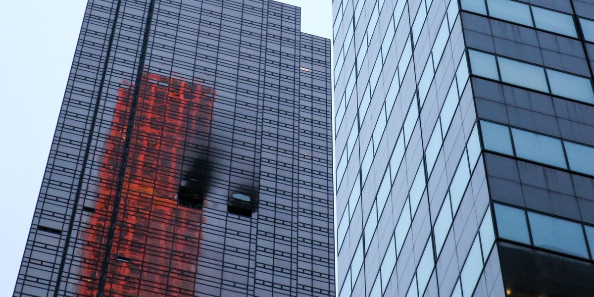 Damaged windows are seen after a fire in a residential unit at Trump Tower in New York