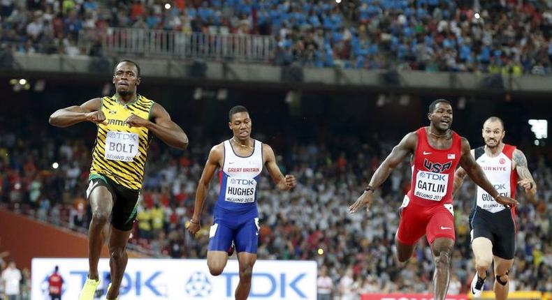 Usain Bolt of Jamaica (L) crosses the finish line ahead of Justin Gatlin (2nd R) from the U.S., Zharnel Hughes of Britain (2nd L) and Ramil Guliyev of Turkey in the men's 200m final during the 15th IAAF World Championships at the National Stadium in Beijing, China August 27, 2015. 