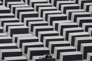 FILE PHOTO: A girl rests on a concrete column of the Holocaust memorial in Berlin