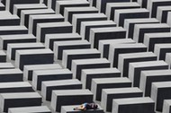 FILE PHOTO: A girl rests on a concrete column of the Holocaust memorial in Berlin