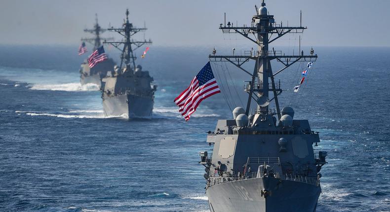 The Arleigh Burke-class guided-missile destroyers USS Preble (DDG 88), USS Halsey (DDG 97) and USS Sampson (DDG 102) are underway behind the aircraft carrier USS Theodore Roosevelt (CVN 71)