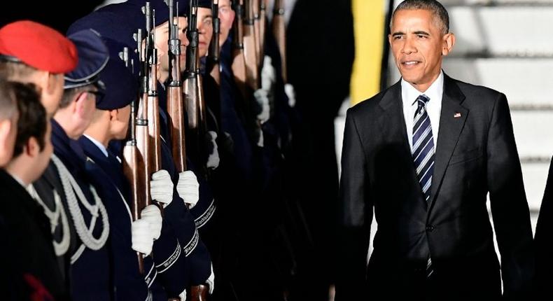 US President Barack Obama is greeted by a guard of honor after disembarking from Air Force One on November 16, 2016 at Berlin's Tegel airport