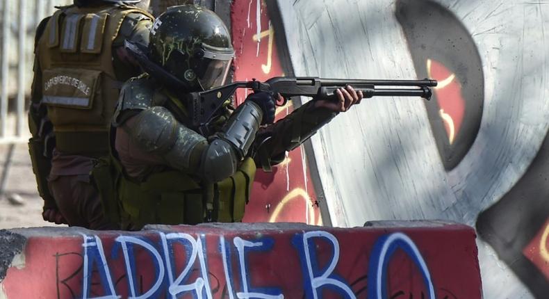 Riot police in Chile take aim at protesters during anti-government demonstrations in Santiago on February 21