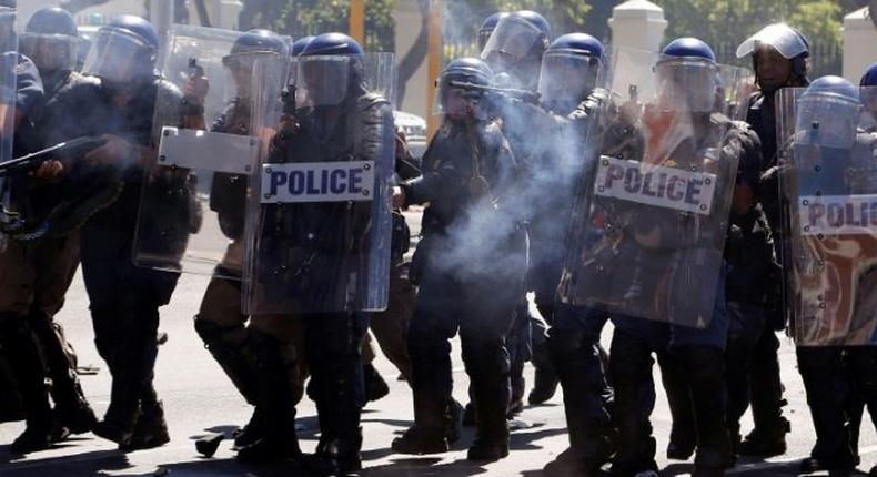 South African Police attend a protest outside Parliament in Cape Town