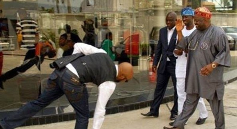 Banky W prostrating for Dele Momodu