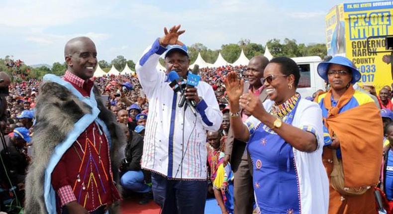 Narok West MP Patrick Ntutu (left) is welcomed to CCM party by leader Isaac Ruto (center) as Ms Lydia Ntimama looks on. 