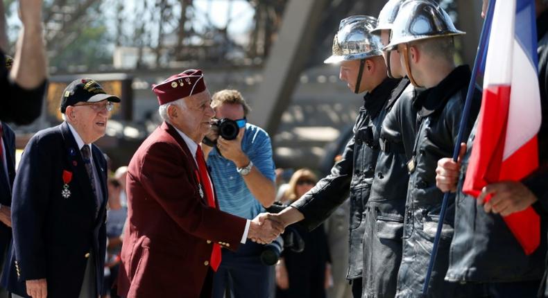 A veteran meets firefighters at the Eiffel Tower