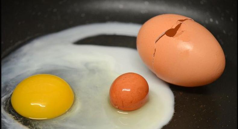 Woman cracks open an egg and finds another one inside