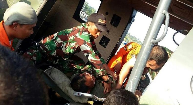 A photo released on November 28, 2016 shows Indonesian pilot Abdi Damain being rescued three days after his helicopter crashed in Kalimantan