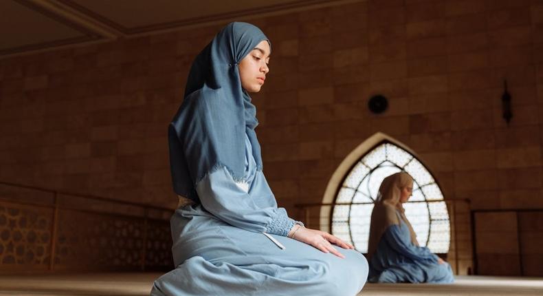 A Muslim woman during prayer time [Image Credit: Thirdman]