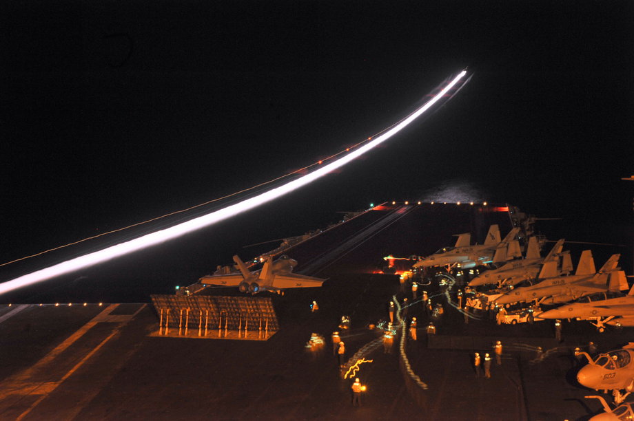 An F/A-18E Super Hornet assigned to the Knighthawks of Strike Fighter Squadron 136 prepares to launch from catapult two during night-flight operations aboard the aircraft carrier USS Enterprise.