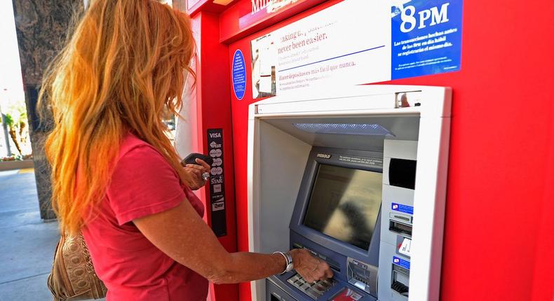 woman using bank ATM